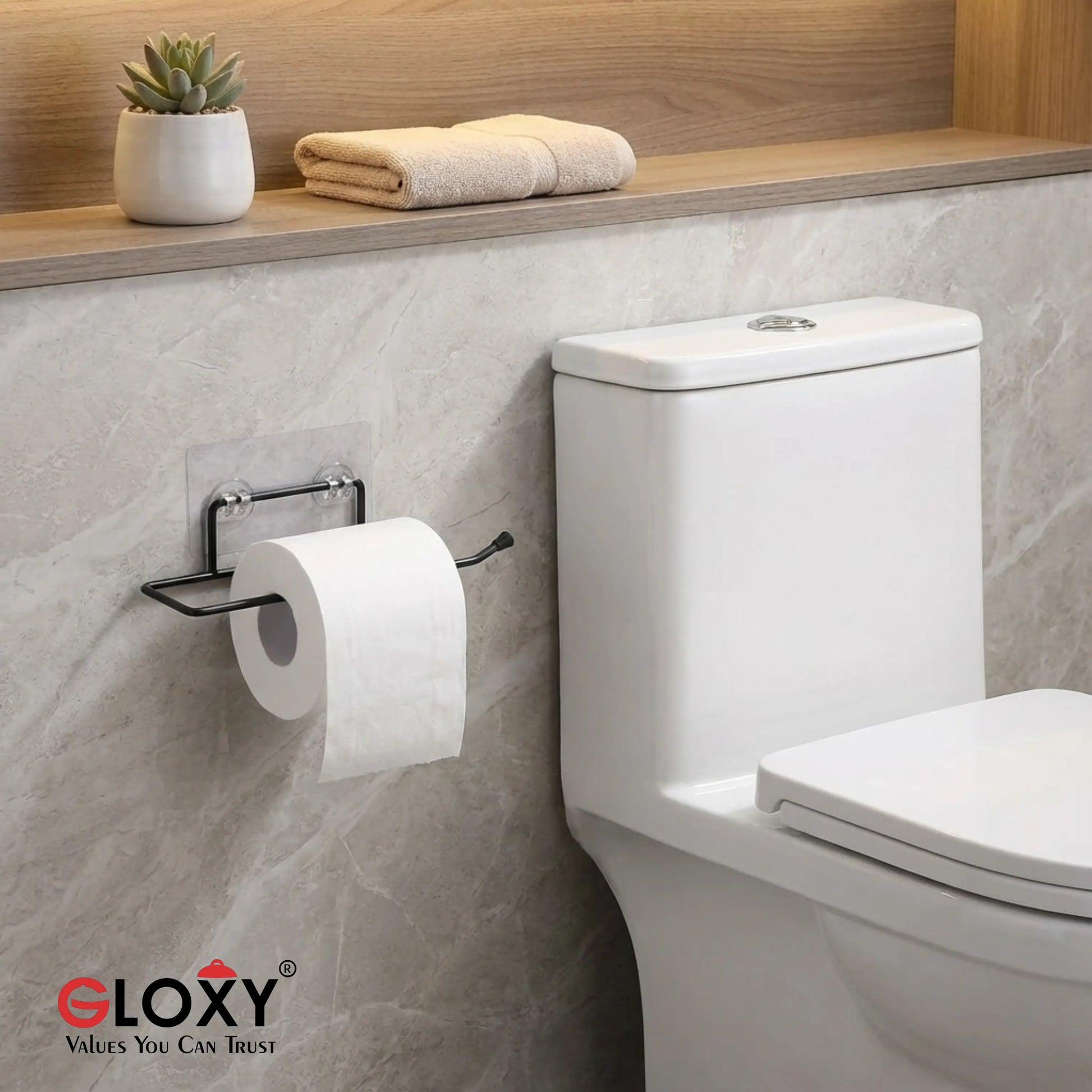 Bathroom setting with a toilet, toilet paper holder, and towels on a shelf.