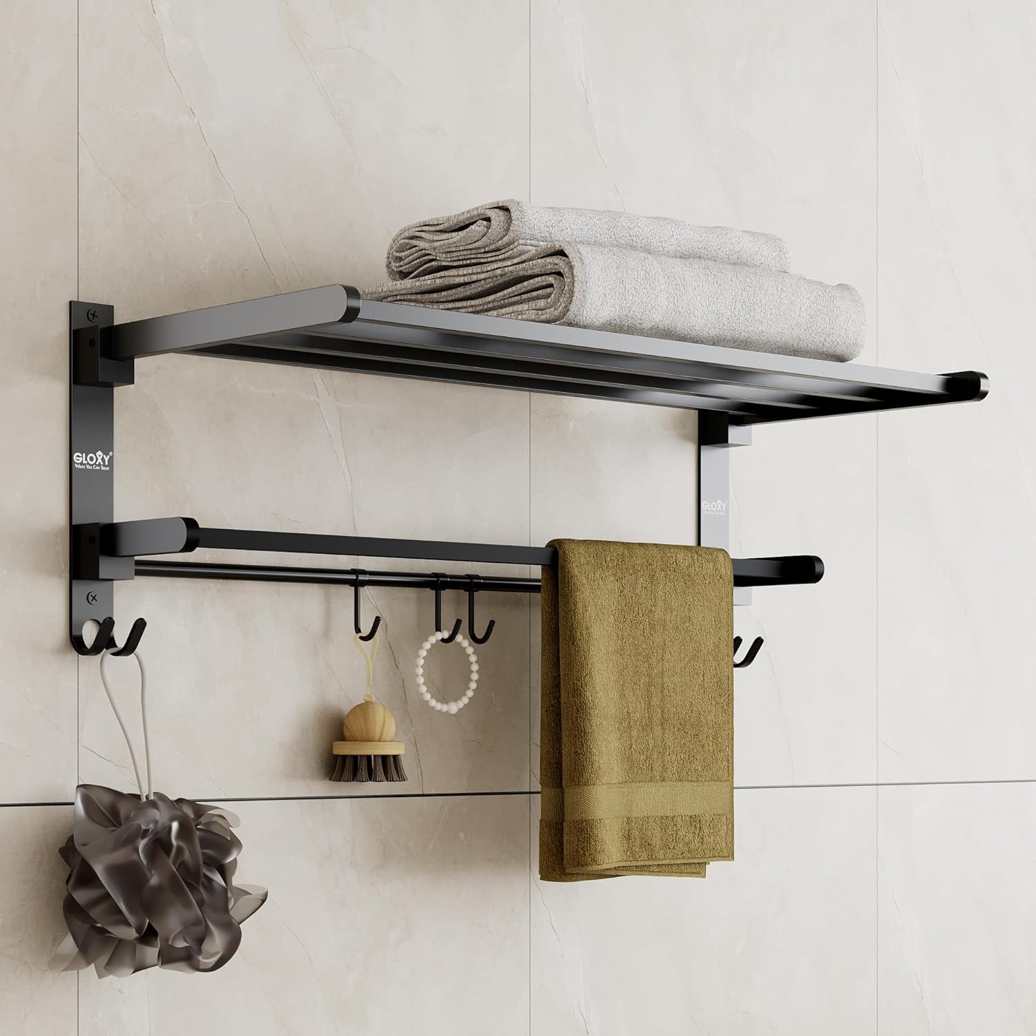 Black towel rack with hooks and folded towels on a tiled wall