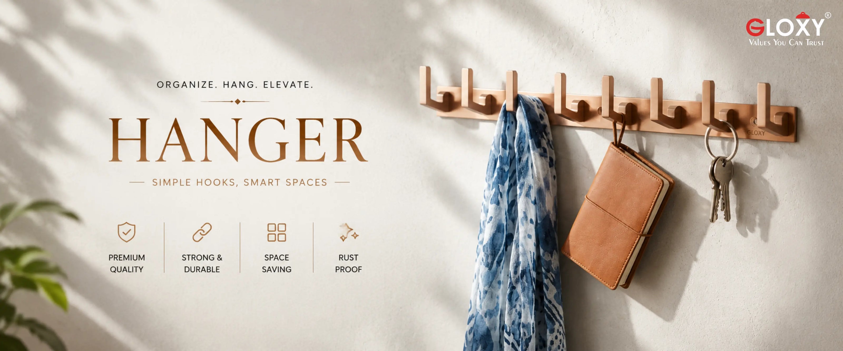 A wall-mounted wooden coat rack with multiple hooks, shown hanging a blue patterned scarf, a brown leather wallet, and keys on a light wall. The left side includes marketing text reading 'HANGER' and feature icons, and the top right shows the ELOXY brand logo.
