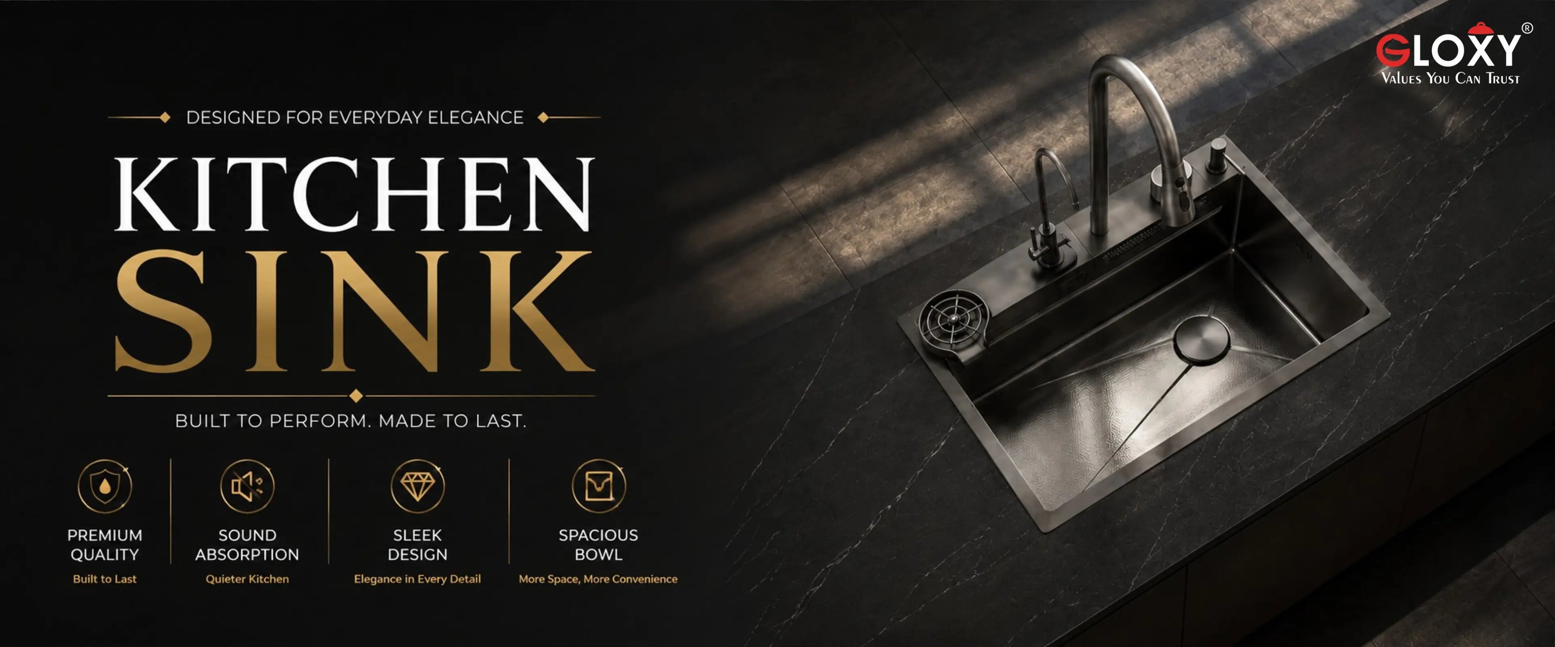 A dark stainless steel kitchen sink with a curved faucet shown on a black marble countertop in a dramatic interior setting. Large text on the left reads 'KITCHEN SINK' with smaller feature callouts, and the ELOXY brand logo appears in the top right corner.