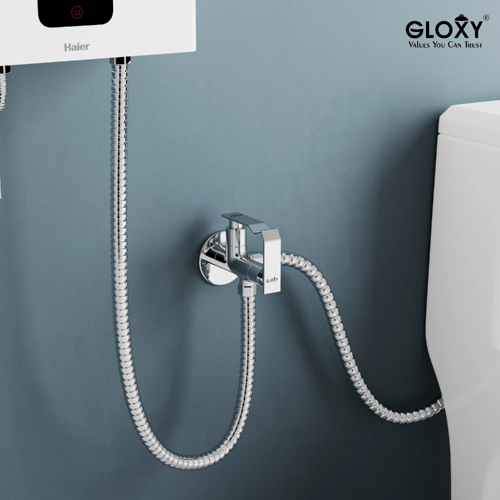 Chrome water hose attachment on a gray wall.