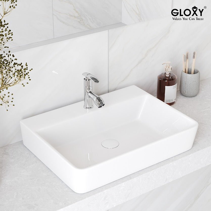 White rectangular sink with silver faucet on a light gray countertop, Gloxy brand visible.