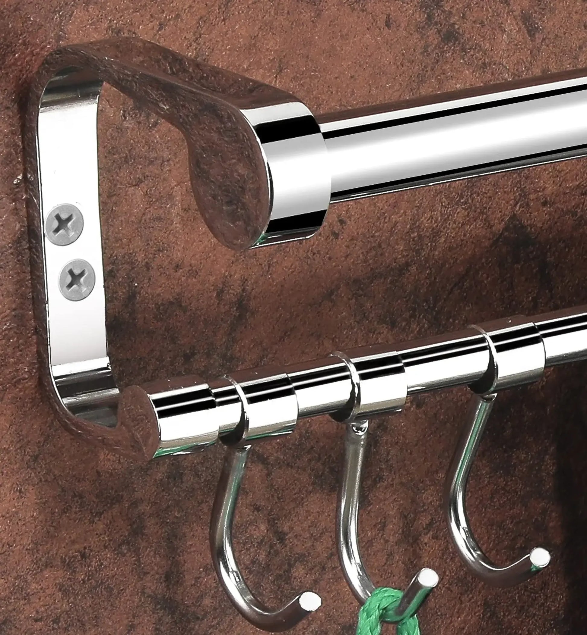 Chrome towel rack with hooks on a textured brown background