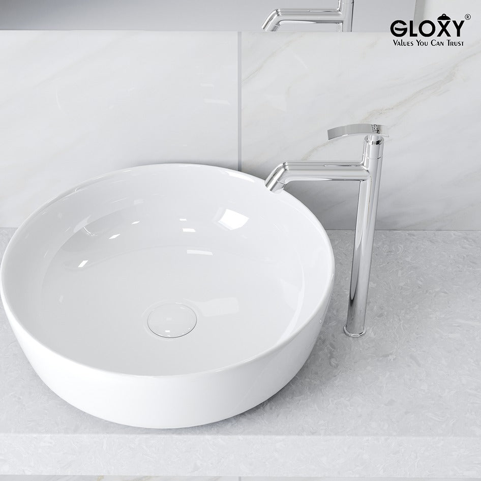 White round sink with a chrome faucet on a light gray countertop.