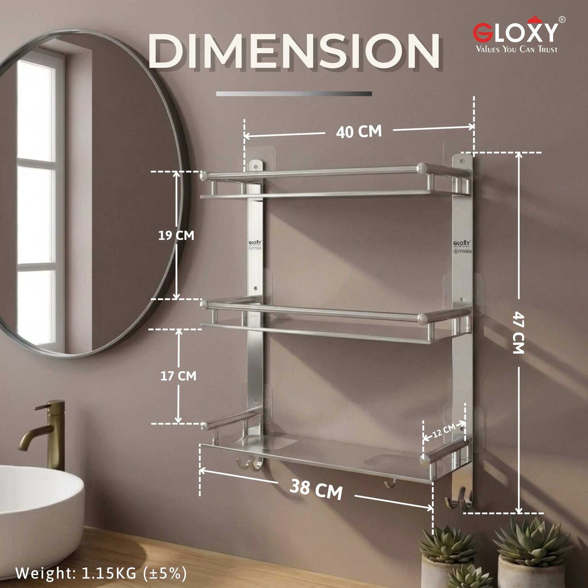 A wall-mounted three-tier bathroom towel rack with dimension annotations showing 40 cm shelf width, 19 cm and 17 cm vertical spacing, 47 cm total height, 38 cm base width, and weight 1.15KG, shown against a bathroom wall with a mirror, sink, and plants.