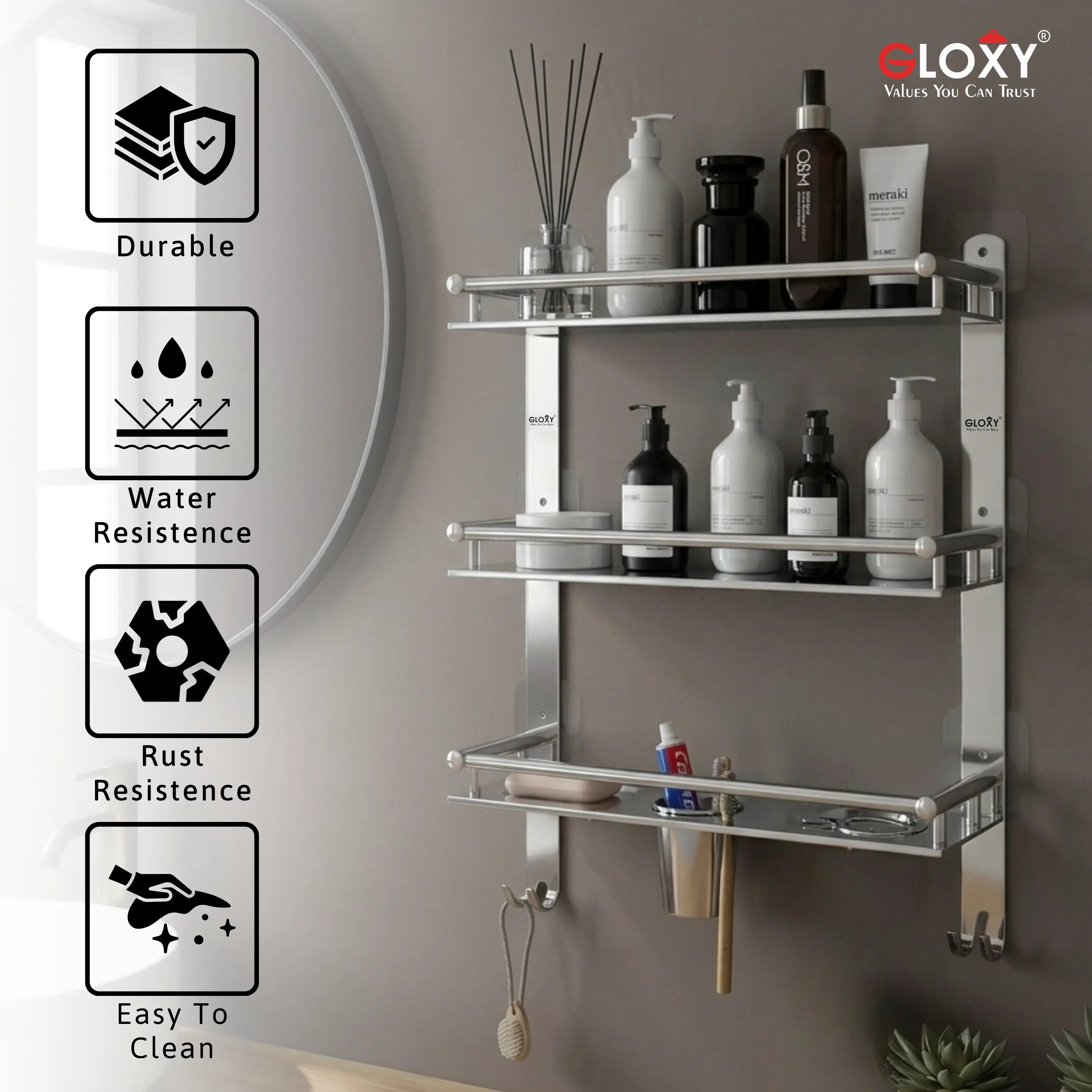 A wall-mounted three-tier stainless steel bathroom shelf with hooks, shown against a gray wall with toiletries on the shelves. The image includes feature callout icons on the left for durability, water resistance, rust resistance, and easy cleaning, and the brand name GLOXY in the top right corner.