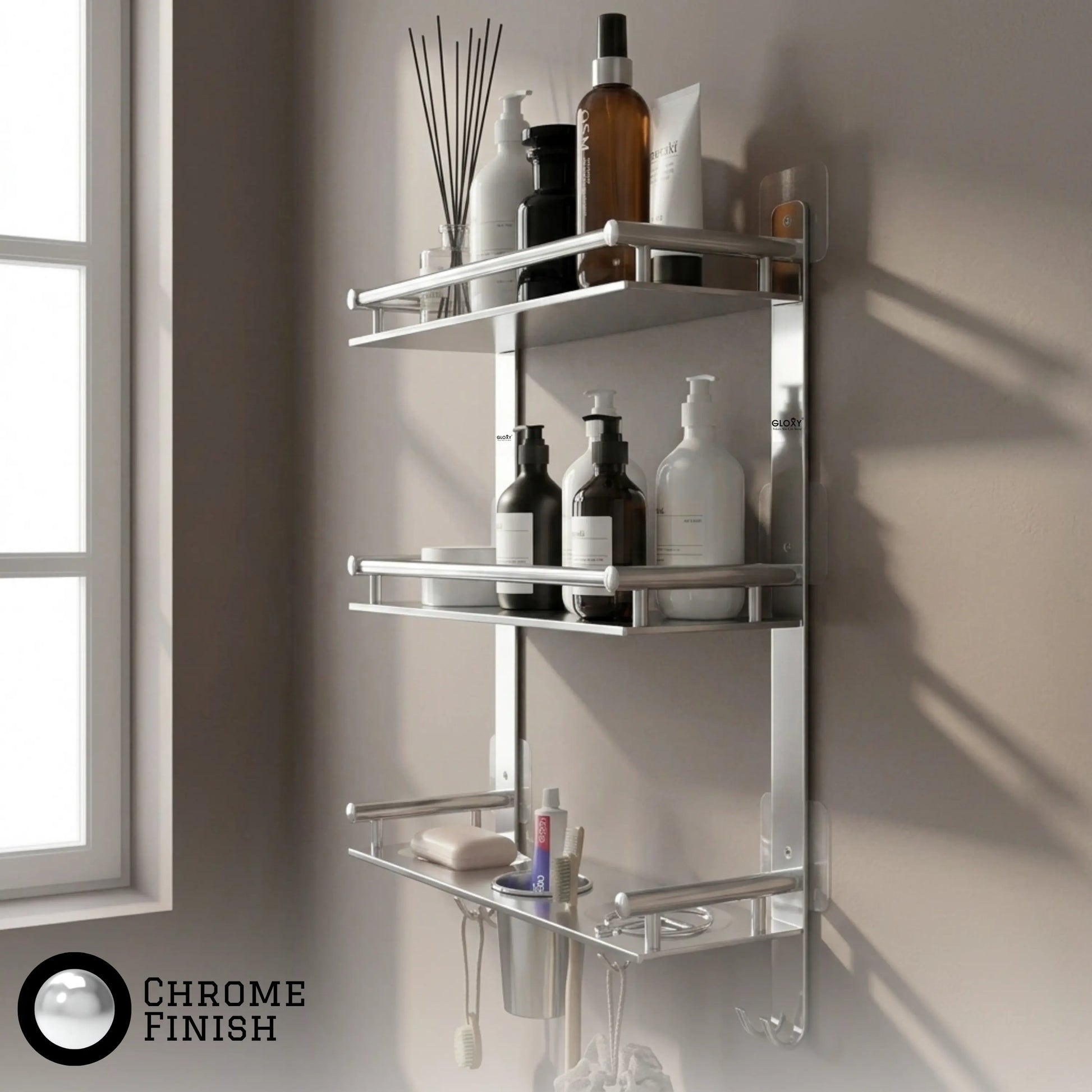 A wall-mounted chrome bathroom shelf set with three tiers, shown holding toiletries against a beige wall next to a window. A 'CHROME FINISH' badge is visible in the bottom-left corner.