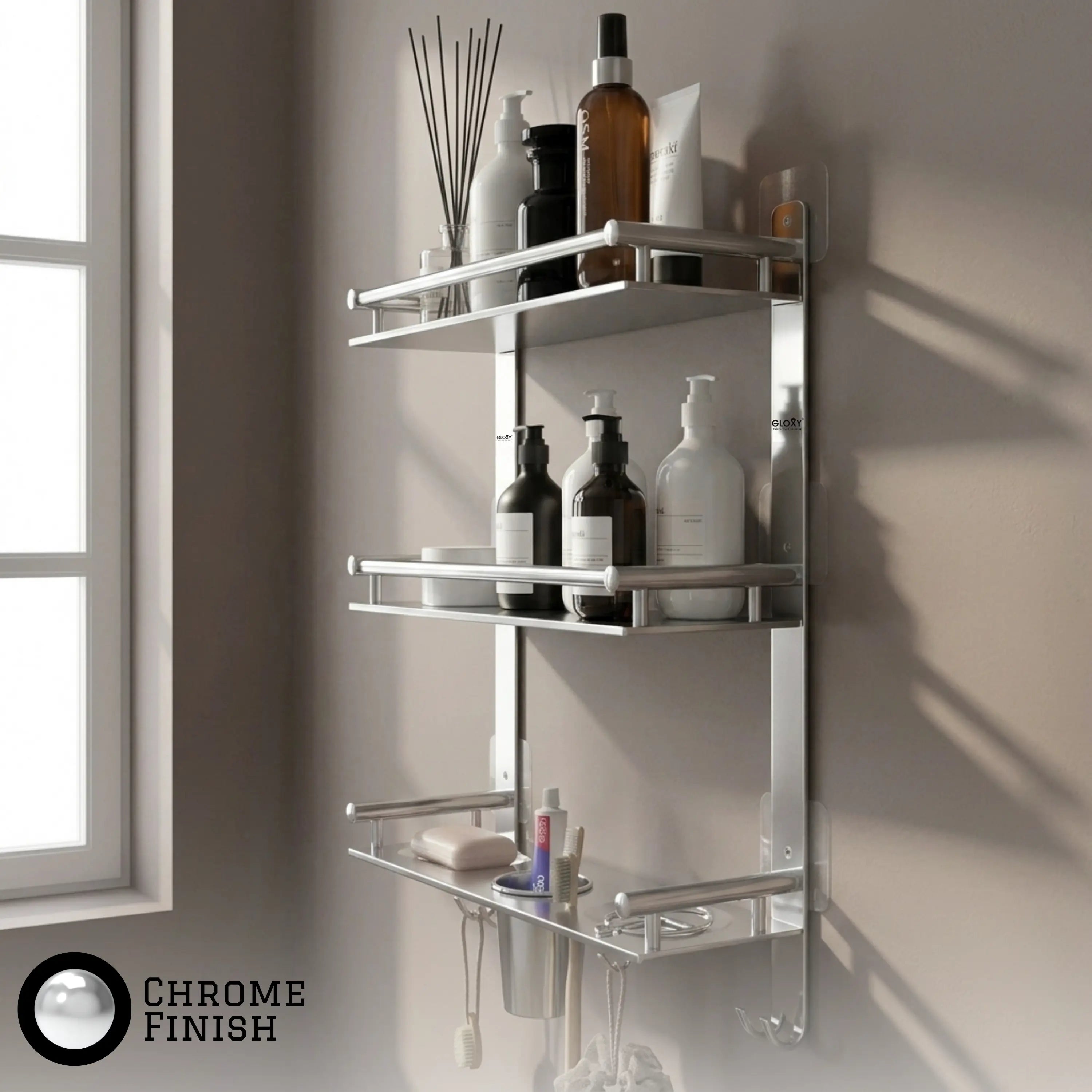 A wall-mounted chrome bathroom shelf set with three tiers, shown holding toiletries against a beige wall next to a window. A 'CHROME FINISH' badge is visible in the bottom-left corner.