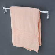  a stainless steel towel rod with a nickel-chrome plating and a pink towel hanging on mounted on a gray wall.