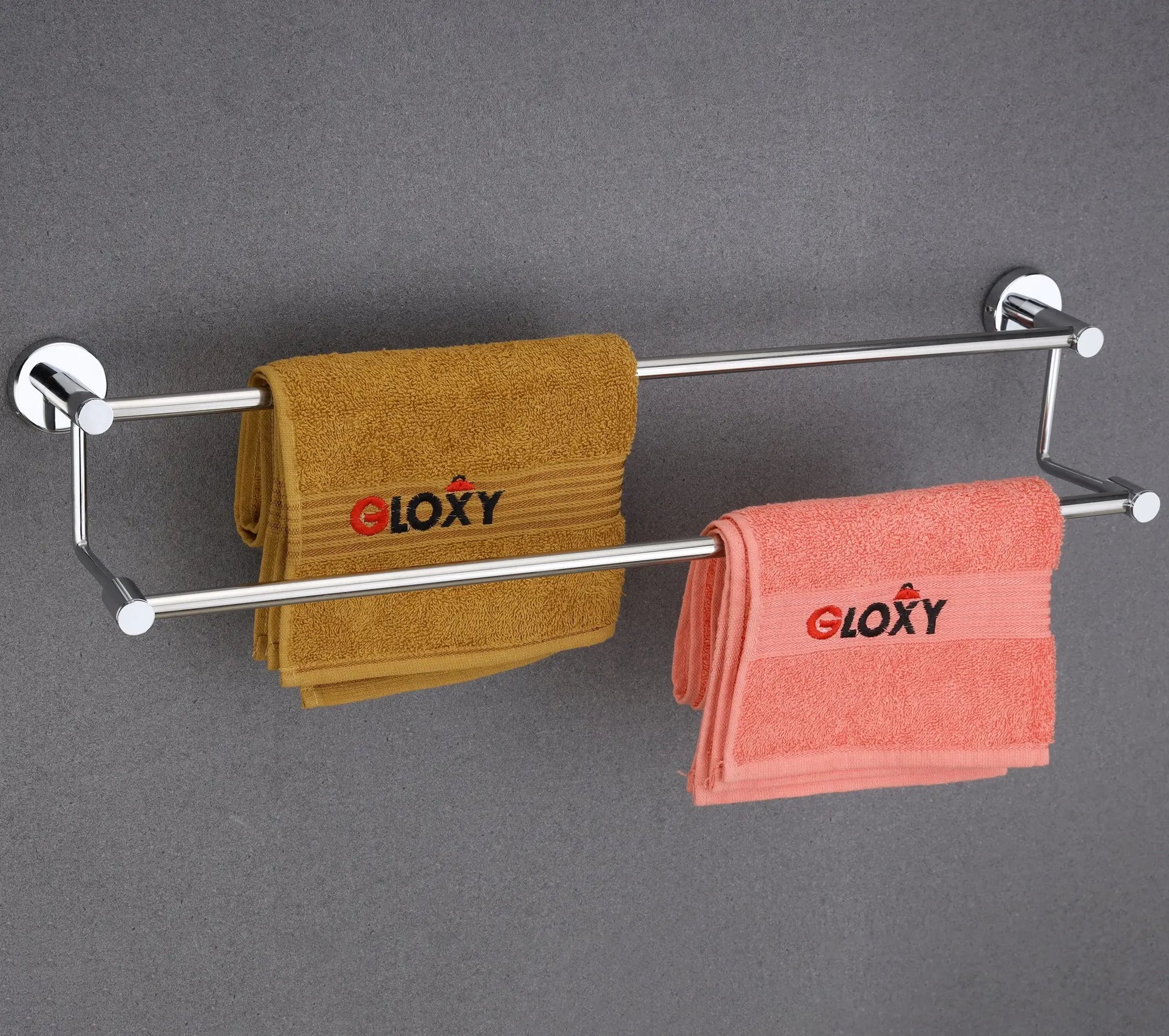 Towel rack with two towels on a gray wall