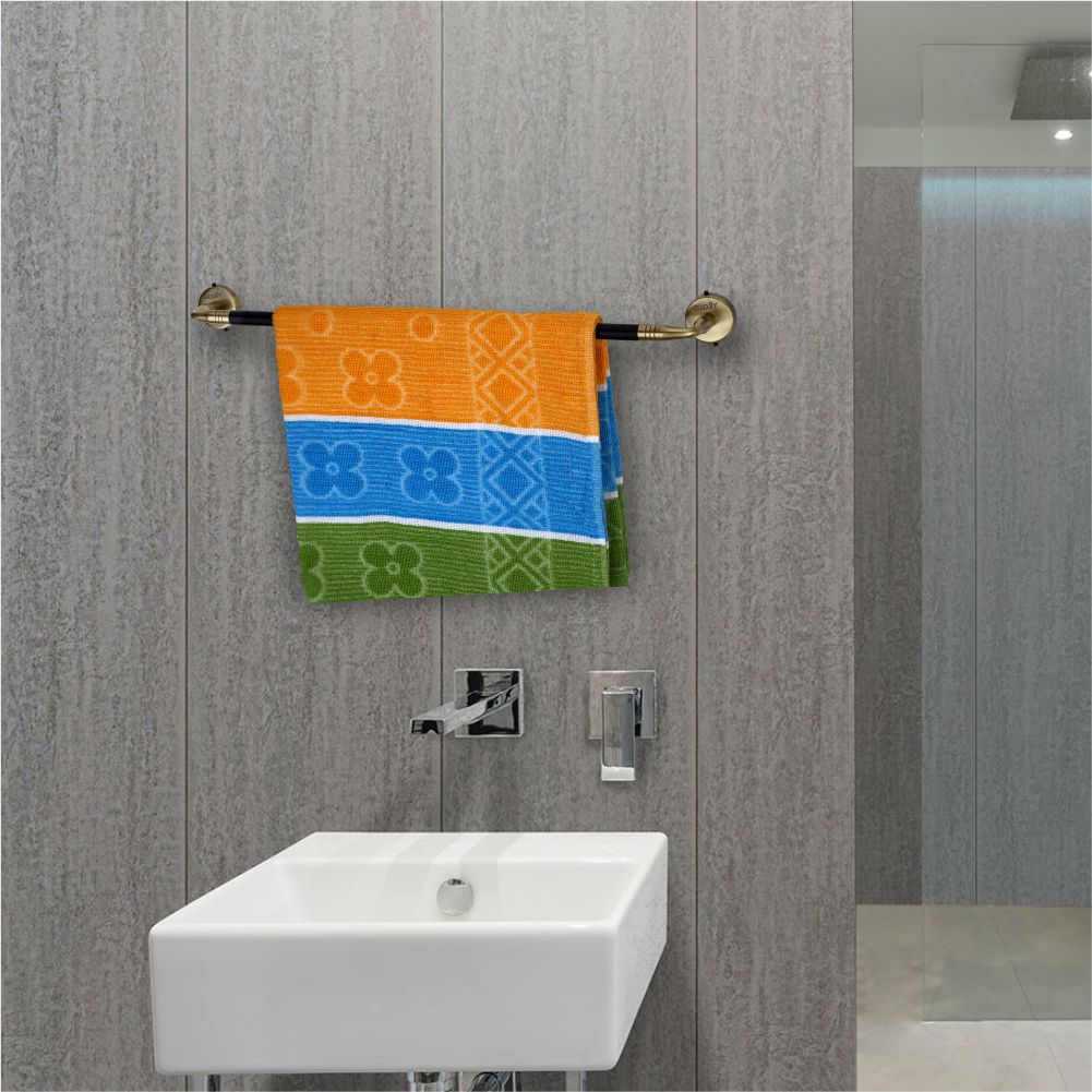 Colorful towel hanging on a towel rack above a sink with gray walls.