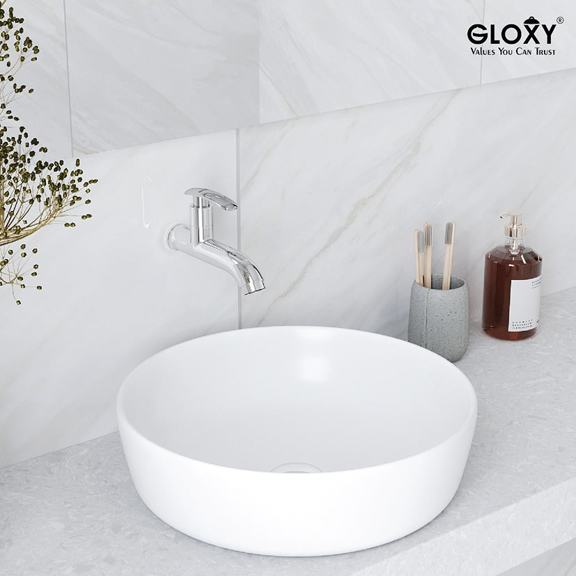 chrome faucets with white round sink in a bathroom setting, featuring Gloxy brand.