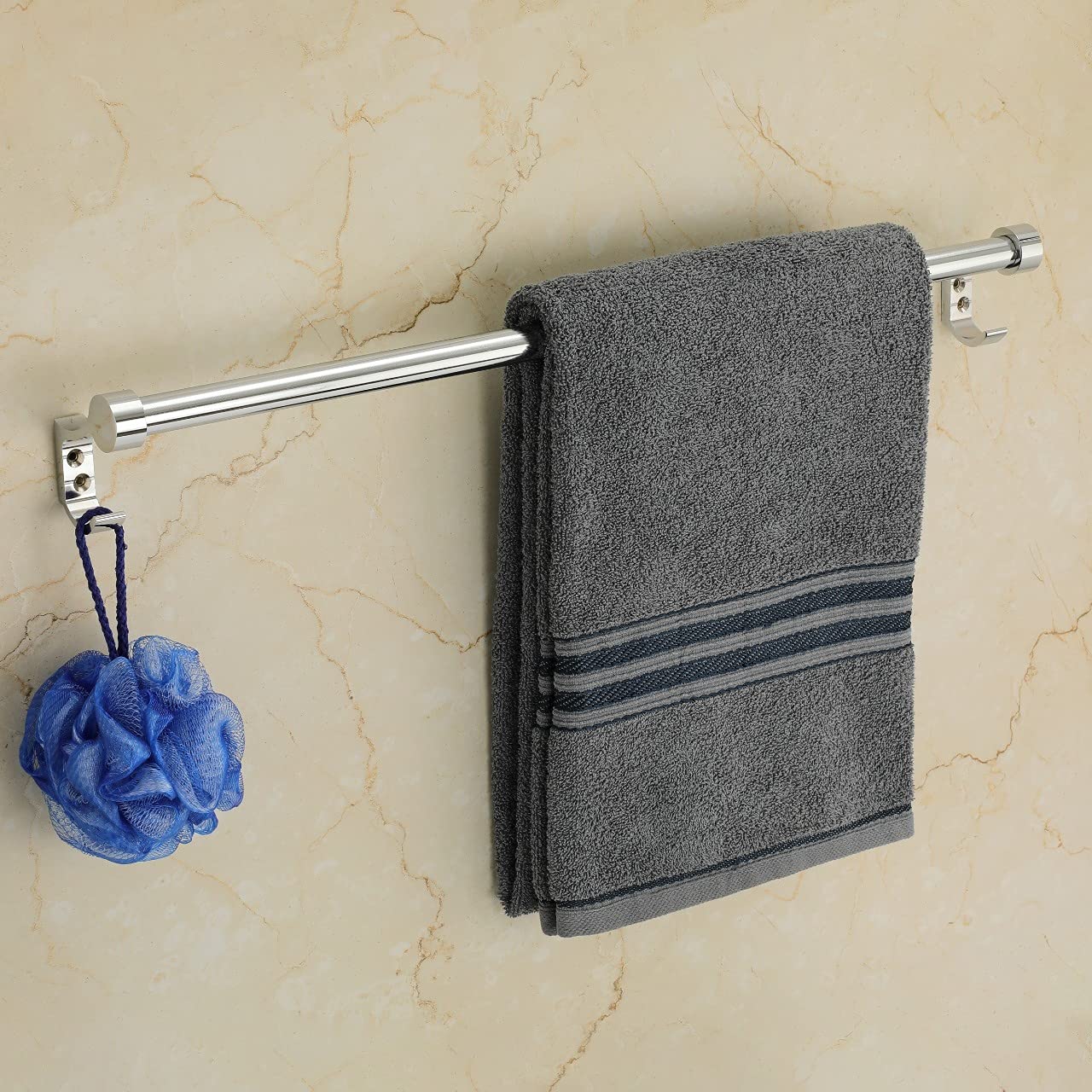 A stainless steel towel rod with a hook and a folded towel hanging on it, mounted on a wall.
