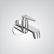 Chrome wall-mounted faucet on a light gray background